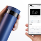 A photo of a person holding a smart water bottle and a phone